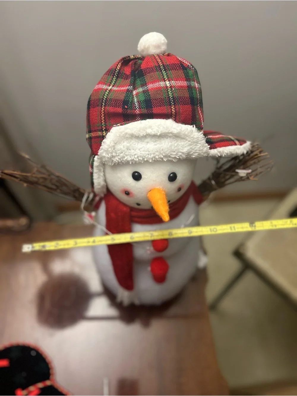 Snowman decoration with twig arms, plaid hat and Santa accent lights New
